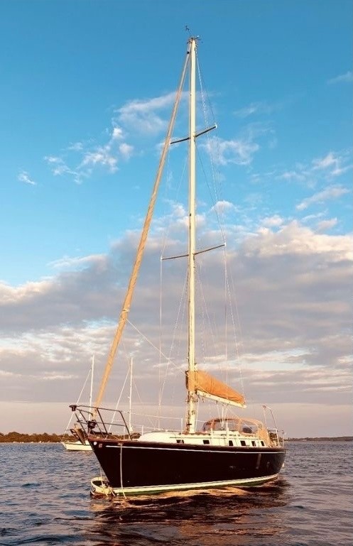 Classic yacht at anchor at golden hour